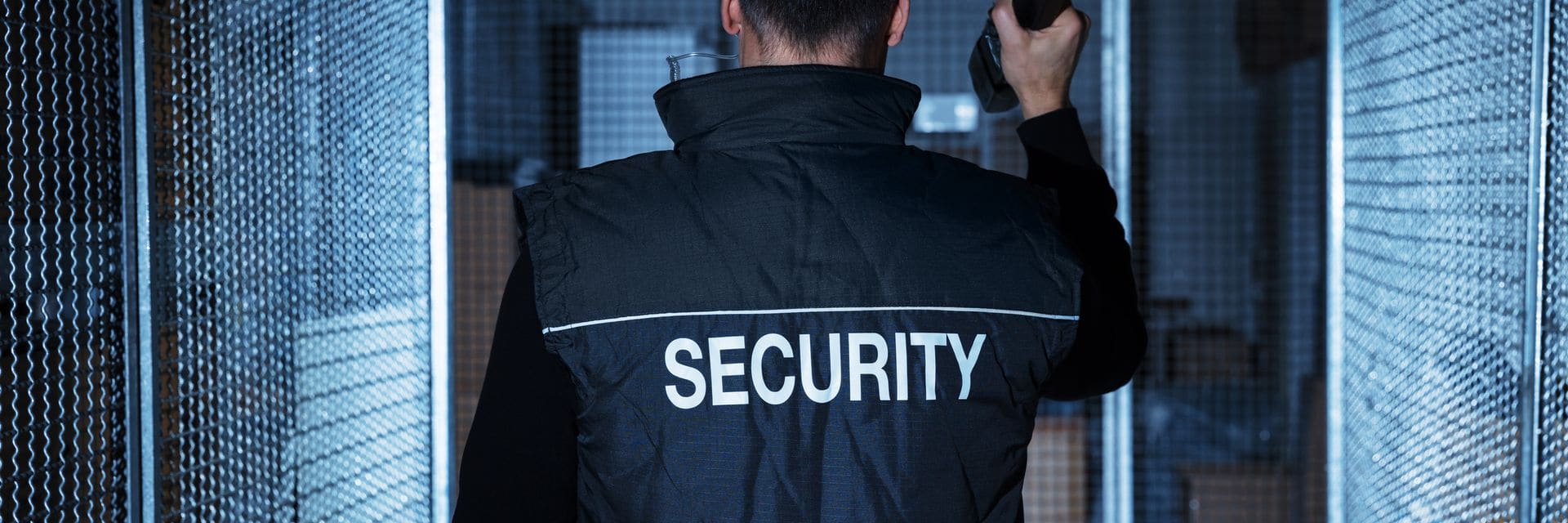 Security guard using a two-way radio on patrol