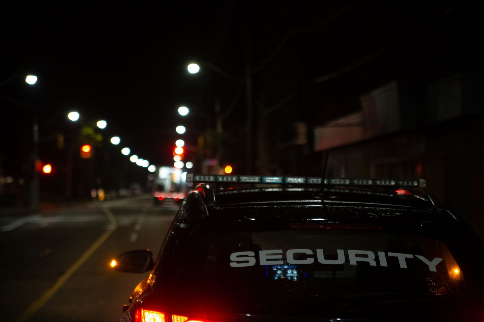 Pride Services Group patrol vehicle on a city street at night