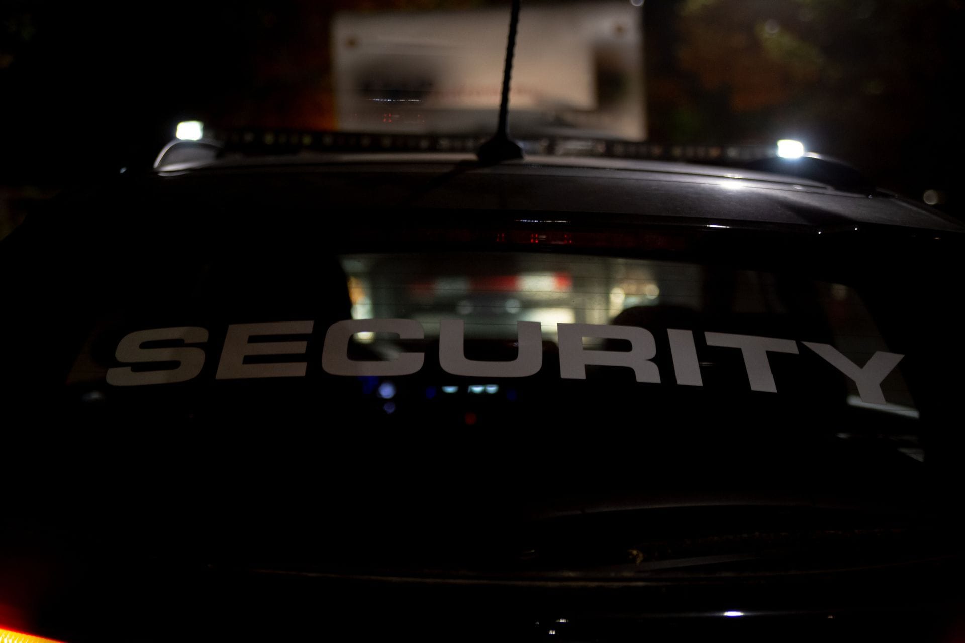 Security patrol vehicle with lightbar at night